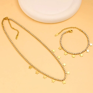 Detail of elegant gold stainless steel star necklace and bracelet set with rhinestones