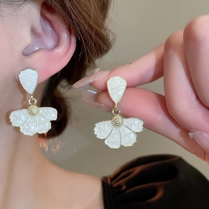 Elegant white flower petal drop earrings with gold metallic centers and enamel finish