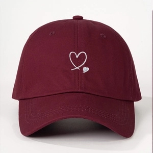 Classic wine red cotton baseball cap with white heart embroidery in center front view