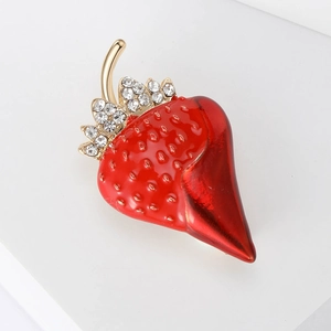 Cute red strawberry enamel brooch with gold leaves and rhinestones on a clean white background
