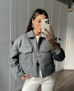 Détails de la veste grise en tweed avec fermeture éclair et grandes poches plaquées