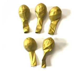 Detailed view of five deflated golden metallic latex balloons on a white surface