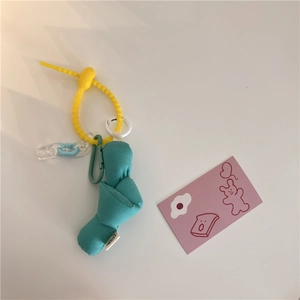 Detail of blue cotton knot pendant with yellow silicone strap and acrylic chain