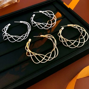 Chunky hollow twisted C-shape hoop earrings in woven gold and silver metallic finishes