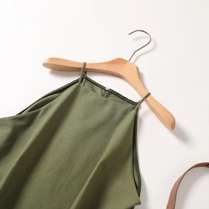 Detail of green halter top featuring cotton linen texture and delicate shoulder straps