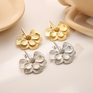 Elegant 18k gold and silver plated flower earrings with textured petals on display