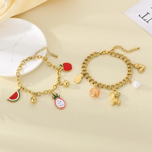 Detail of 18K gold plated fruit charm bracelet featuring colorful enamel pendants