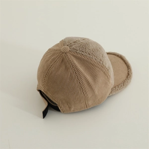 Detail view of khaki corduroy and sherpa fleece texture on a kids winter baseball cap