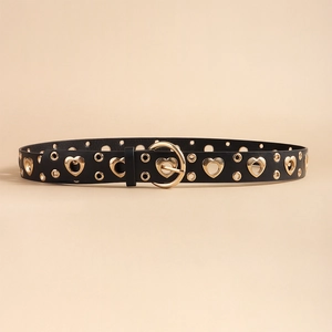 Detail of black leather punk belt featuring golden heart-shaped metal eyelets and D-ring buckle