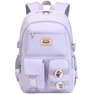 Detailed front view of light purple school backpack with decorative badges and multiple pockets