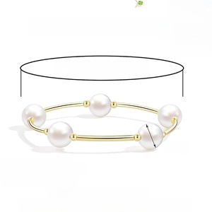 Elegant 10mm faux pearl stretch bracelet with gold curved tubes on a clean background