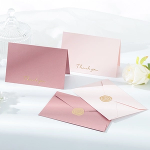 Detail of pink Thank You cards with gold lettering and floral rose wax seals on envelopes
