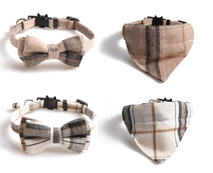 Detail of plaid pet collar with bowknot, triangle bandana, and golden security bell