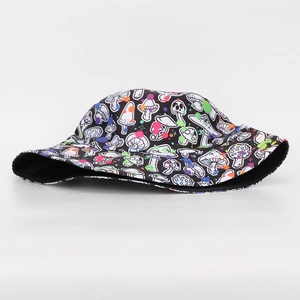 Close-up of mushroom graphic print and neon paint splatter on black canvas bucket hat