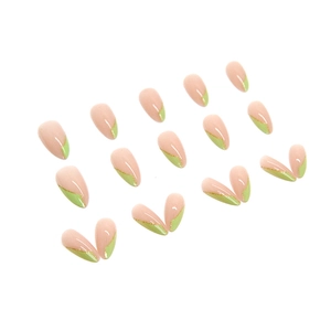 French tip press-on nails in almond shape with green accents and gold glitter details