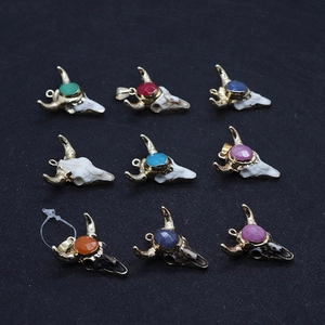 Detailed view of nine bull head pendants with assorted colorful gemstones in gold settings