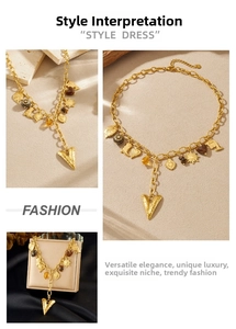 Detail view of vintage gold-plated stainless steel necklace with multi-element heart pendants