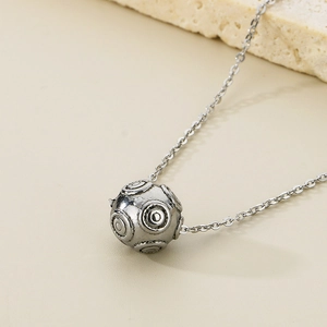 Minimalist silver stainless steel necklace with geometric round sphere pendant on stone