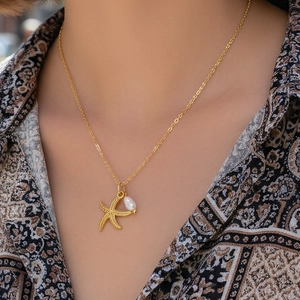 Elegant 18K gold plated necklace with starfish pendant and white pearl on model