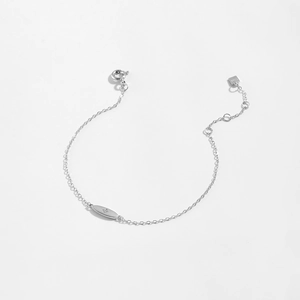 Macro shot of 925 sterling silver chain featuring an oval charm with star engraving