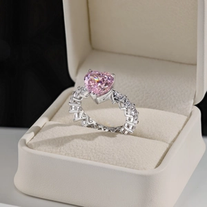 Macro view of S925 sterling silver ring band with pink heart gem and clear zircon pavé