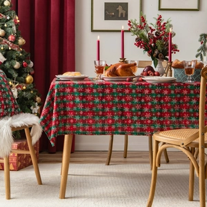 Christmas red and green plaid table runner with snowflake patterns on a dining table