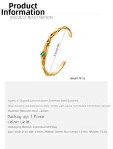 Detailed view of gold C-shaped stainless steel bracelet with green zircon and hammered texture