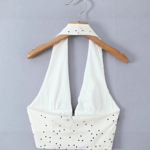 Haut dos nu à pois blanc et noir avec décolleté en V profond et fermeture éclair
