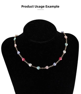 Colorful heart-shaped bead chain on a jewelry bust showing DIY necklace layering style