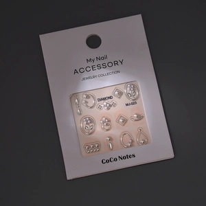 3D nail art accessory kit featuring silver metal flowers, pearls, and geometric charms