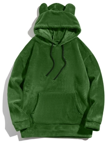 Detail of green fleece hoodie with animal ears and soft plush texture on white background