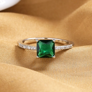 Vintage emerald-cut green zircon ring in silver-tone setting with pave-set side stones