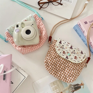 Flat lay of quilted checkered crossbody bags for Instax cameras and small cosmetics