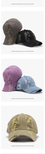 Detail of distressed baseball cap showing frayed edges and washed cotton texture
