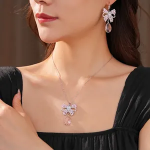 Elegant jewelry set with pink crystal bow necklace and matching teardrop earrings