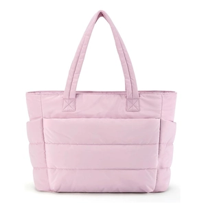 Close-up of pink quilted nylon tote bag showing soft stitched texture and dual handles