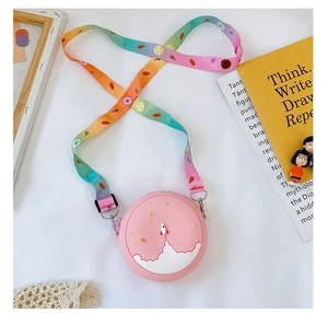 Detail of pink round kids crossbody bag with rocket pattern and rainbow strap