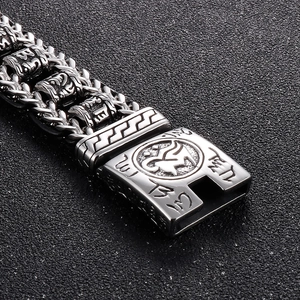 Macro shot of silver titanium steel bracelet featuring intricate mantra engravings