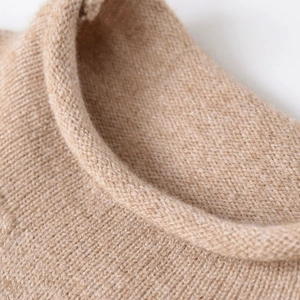 Soft light camel knit top featuring a delicate rolled mock neck and fine texture