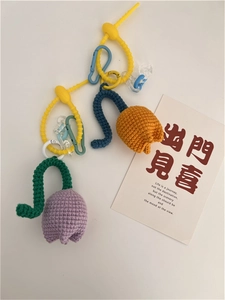 Detail of handmade crochet tulip keychains in purple and orange with silicone straps
