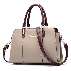 Minimalist beige shoulder bag with burgundy handles and adjustable strap for women