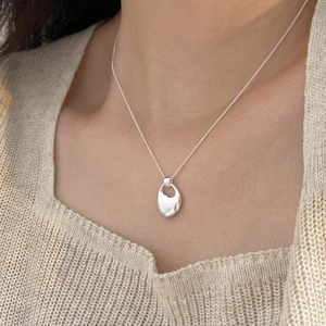 Minimalist 925 sterling silver irregular teardrop necklace on model collarbone