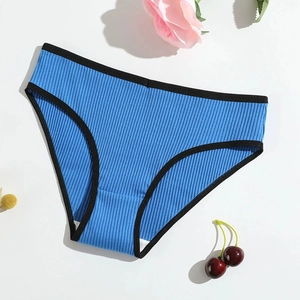 Flat lay of blue ribbed cotton panties for women with black contrast trim on white background
