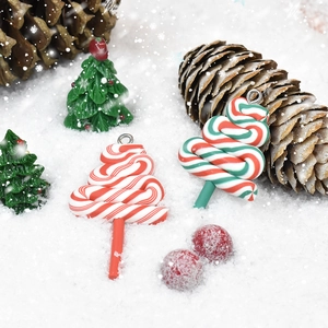 Detailed view of red and green candy cane pendants on snow with festive ornaments