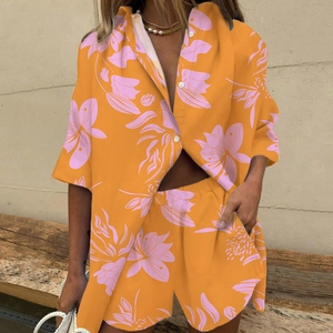 Detail of orange floral two-piece set with short sleeve shirt and elastic waist shorts