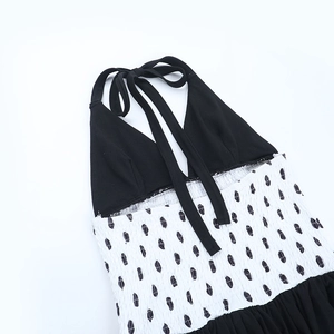 Detailed view of the contrast polka dot halter neck dress with elastic smocked bodice