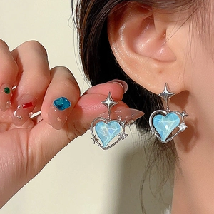 French style blue heart-shaped silver earrings with star details on female model