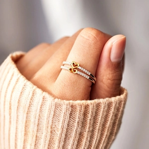 Close-up of S925 silver ring featuring gold infinity and heart symbols with zircon pavé
