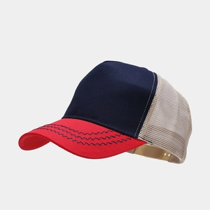 Detail view of trucker hat mesh back and wave stitching on red brim