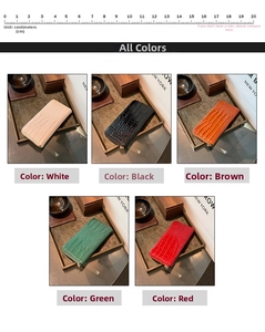 Detail of five faux crocodile pattern long wallets in various colors with a 20cm scale ruler